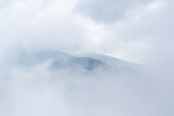 Mountain through clouds