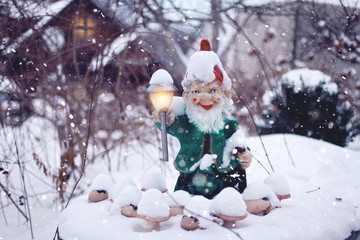 Cute Christmas dwarf with street light in its hand