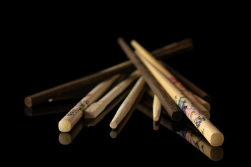 Lot of whole asian brown chopsticks isolated on black glass