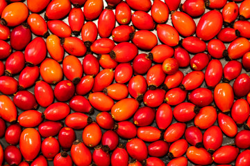 Detail macro view of dog rose hips (latin name Fructus cynosbati) prepared for drying. Dried rose hips are important source of vitamins in alternative medicine. Typical fall berry fruit