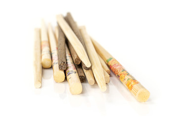 Lot of whole asian brown chopsticks isolated on white background