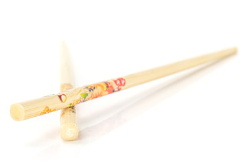 Group of two whole colorful asian brown chopsticks isolated on white background