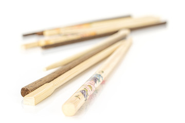 Lot of whole asian brown chopsticks isolated on white background