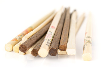 Lot of whole asian brown chopsticks stack isolated on white background