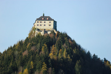Fototapeta na wymiar Austrian old castle on the top of the mountain covered by colorful forest