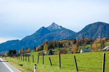 Fototapeta na wymiar View from a car window to the rural alpine landscape