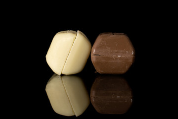 Group of four whole fresh chocolate piece isolated on black glass