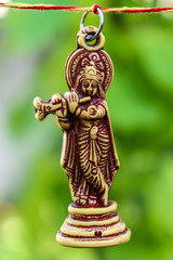 Lord krishna playing flute in green environment peacefully.