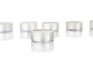 Lot of whole waxy white tea candle isolated on white background