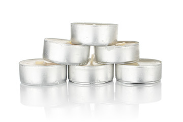 Lot of whole waxy white tea candle isolated on white background