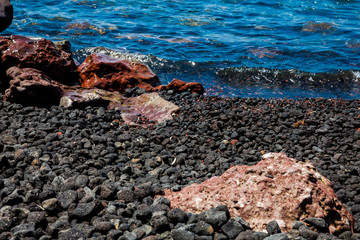 Detail of the rocks on the famous Red Beach at Santorini Island in a beautiful early spring day