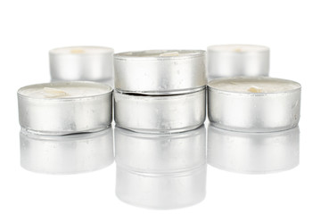 Group of five whole waxy white tea candle isolated on white background