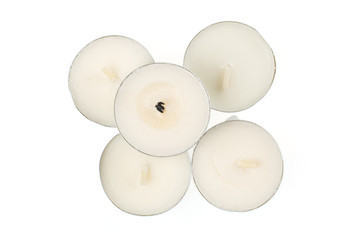 Group of five whole waxy white tea candle flatlay isolated on white background