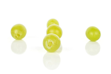 Group of five whole fresh green grape isolated on white background