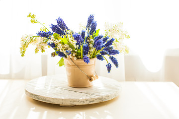 Bunch of grape hyacinths in a ceramic vase