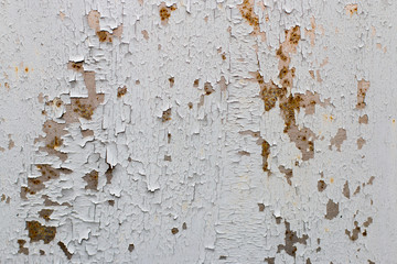 Background. Old gray metal wall with weathered paint, scratches and rust.