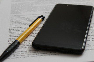 phone and pen for signing the contract