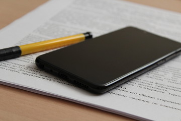 notebook and pen on wooden table