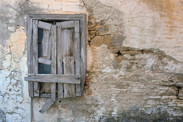 Old plastered wall and window in Monalates on Samos, Greece.