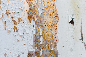 Background. Old gray metal wall with weathered paint, scratches and rust.