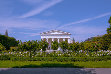 Volksgarten Public Park in Vienna, view on Theseus temple. Column Hall in the garden with beautiful colorful landscape.