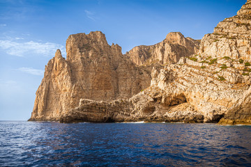 Fototapeta premium Granite cliffs in front of Bombarda Cave, Marettimo, Egadi Islands, Italy
