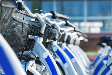 Similar blue bicycles for sharing parked outdoors