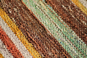 Colorful carpet made of rags, striped pattern detail