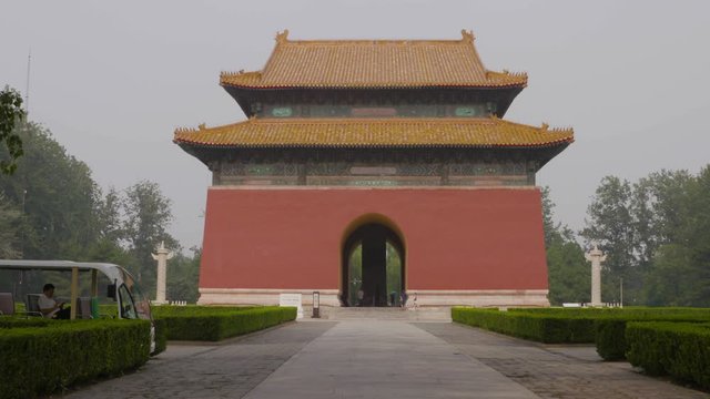 A steady wide shot view of the garden and entrance to the Sacred Way path to the Ming Dynasty Tombs located near Beijing in China.