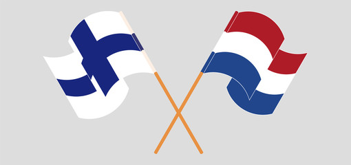 Crossed and waving flags of Finland and Netherlands