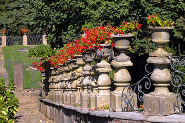 Obraz premium stone vases with flowers in the park garden