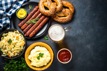 Oktoberfest food - sausage, beer and bretzel.