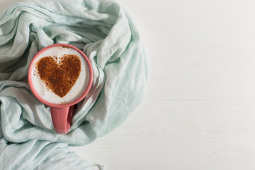 Blue scarf, coffee with a heart pattern on the table, a good morning is the best start day. Autumn...