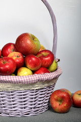 Fototapeta na wymiar A large wicker basket with ripe juicy apples. New crop. On a white background.