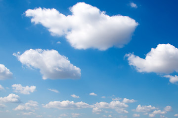 Naklejka na ściany i meble White clouds against a blue sky. The photograph of the sky