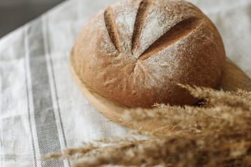 Loaf of bread on a board on a white tablecloth