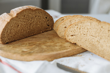 Sliced bread and ears on white tablecloth