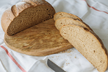 Sliced bread and ears on white tablecloth