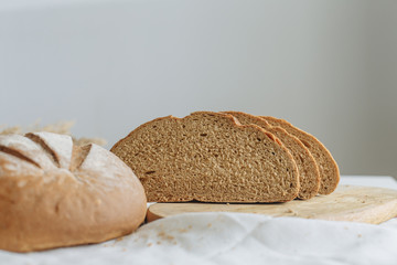 Sliced bread and ears on white tablecloth