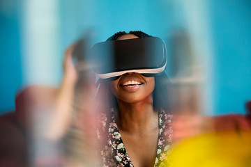 African woman looking through VR headset