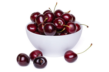 Fresh ripe sweet cherries in a white bowl