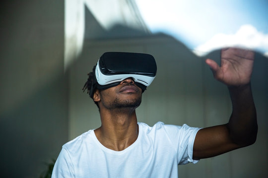 African man looking through VR headset
