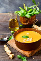 pumpkin soup and bread with basil and crispy crackers, vegan recipe. Autumn cream soup of seasonal product
