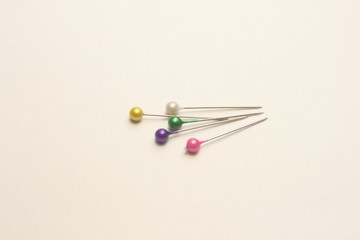  multicolored stationery pins on a white background