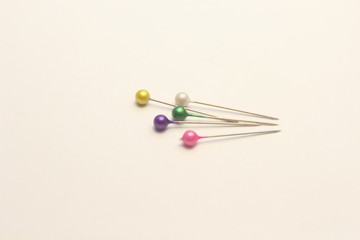  multicolored stationery pins on a white background