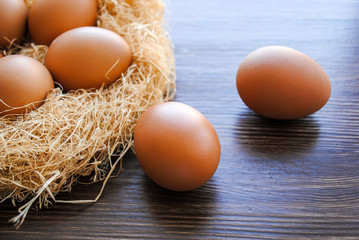 Nest with brown chicken eggs.