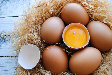 Nest with brown chicken eggs.