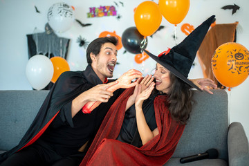 happy couple of love  in costumes and makeup on a celebration of Halloween