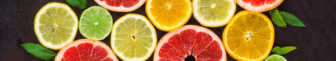 banner of citrus food pattern on white background - assorted citrus fruits with mint leaves on black background