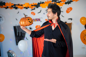 Fototapeta premium happy couple of love in costumes and makeup on a celebration of Halloween